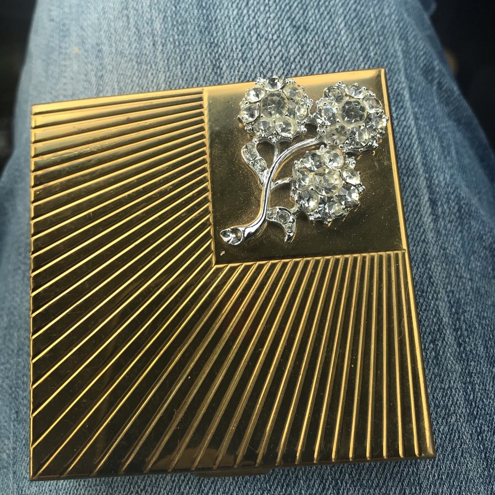 Vintage Mid Century gold toned Volupte compact with a rhinestone flower design